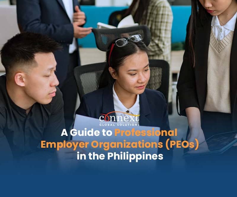 A-Guide-to-Professional-Employer-Organizations-PEOs-in-the-Philippines-3-asian-people-in-corporate-attire-meeting-in-office-with-tablet-and-papers-1@1x_1