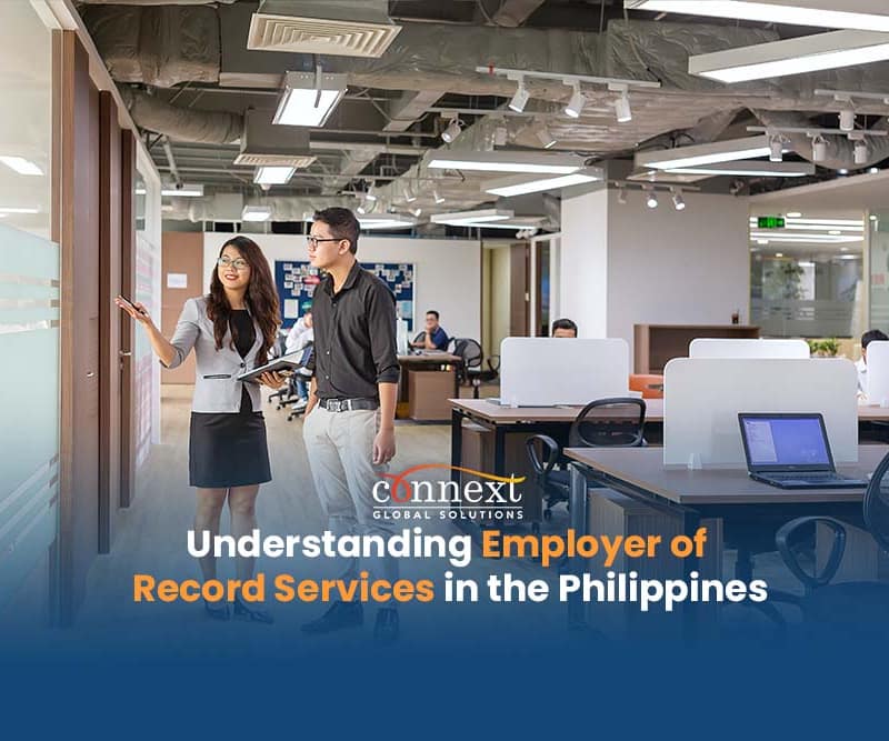 Understanding-Employer-of-Record-Services-in-the-Philippines-asian-discussing-pointing-to-window-inside-office-workstation-space-call-center