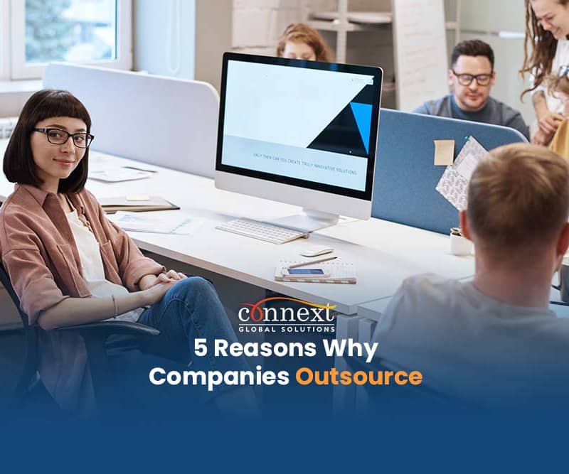 5-Reasons-Why-Companies-Outsource-woman-in-office-desk-space-with-co-workers