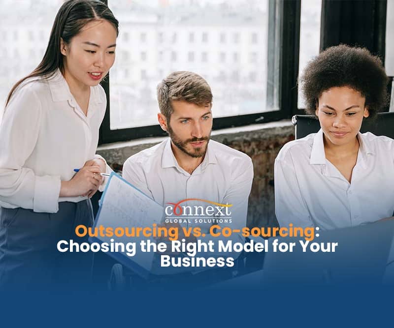 Outsourcing-vs.-Co-sourcing-Choosing-the-Right-Model-for-Your-Business-team-meeting-in-corporate-attire-using-laptop-in-office