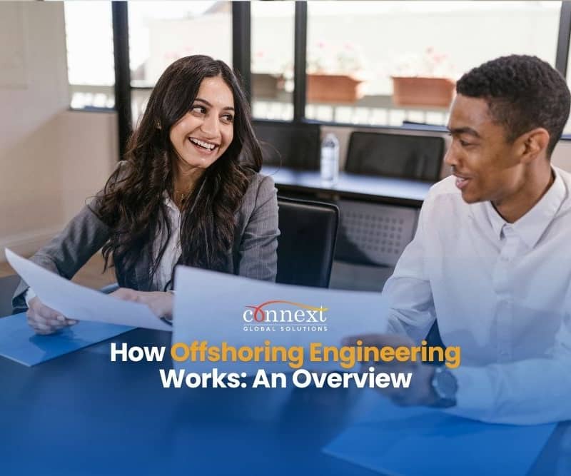 woman-in-gray-blazer-holding-white-paper-sitting-beside-man-in-white-long-sleeve-shirt How Offshoring Engineering Works An Overview